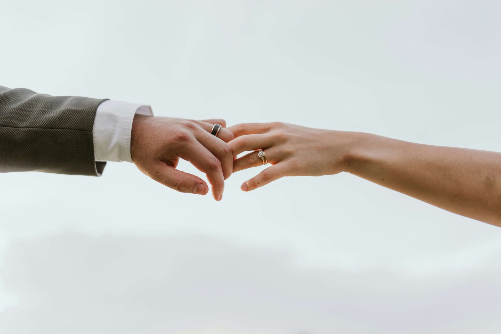 A couple holding hands and wearing wedding rings
