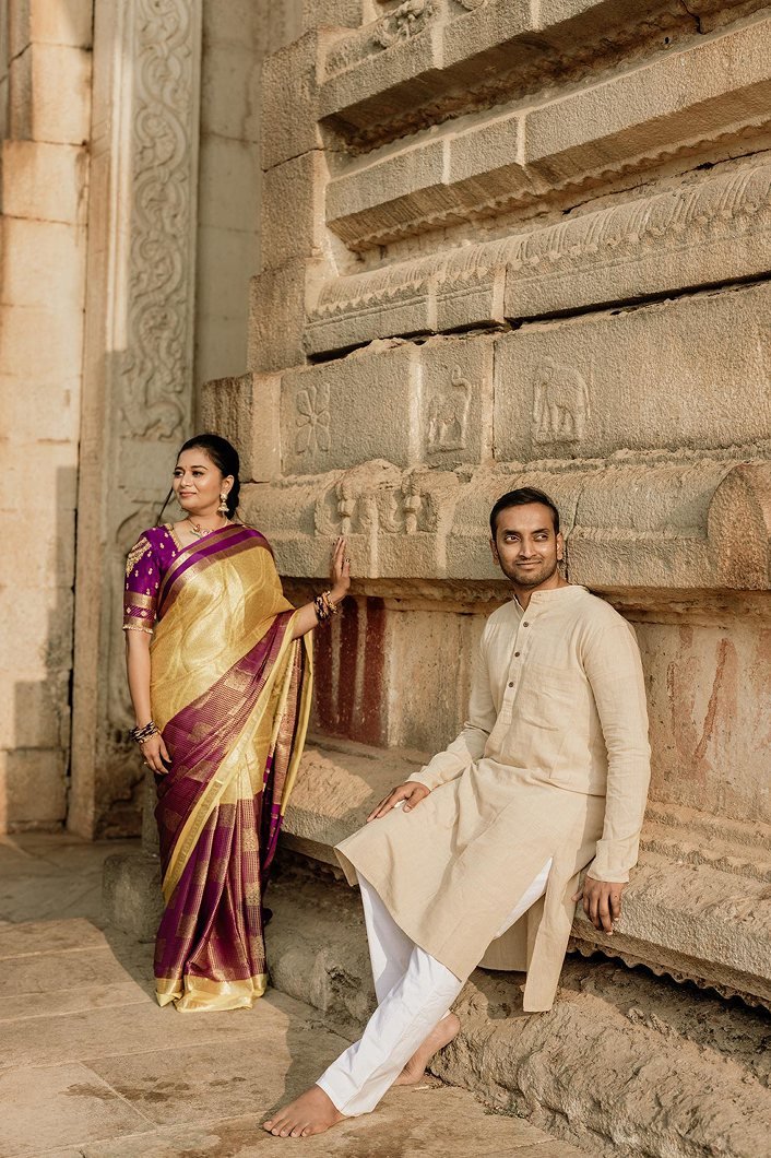 A Marathi couple in traditional attire at a heritage setting